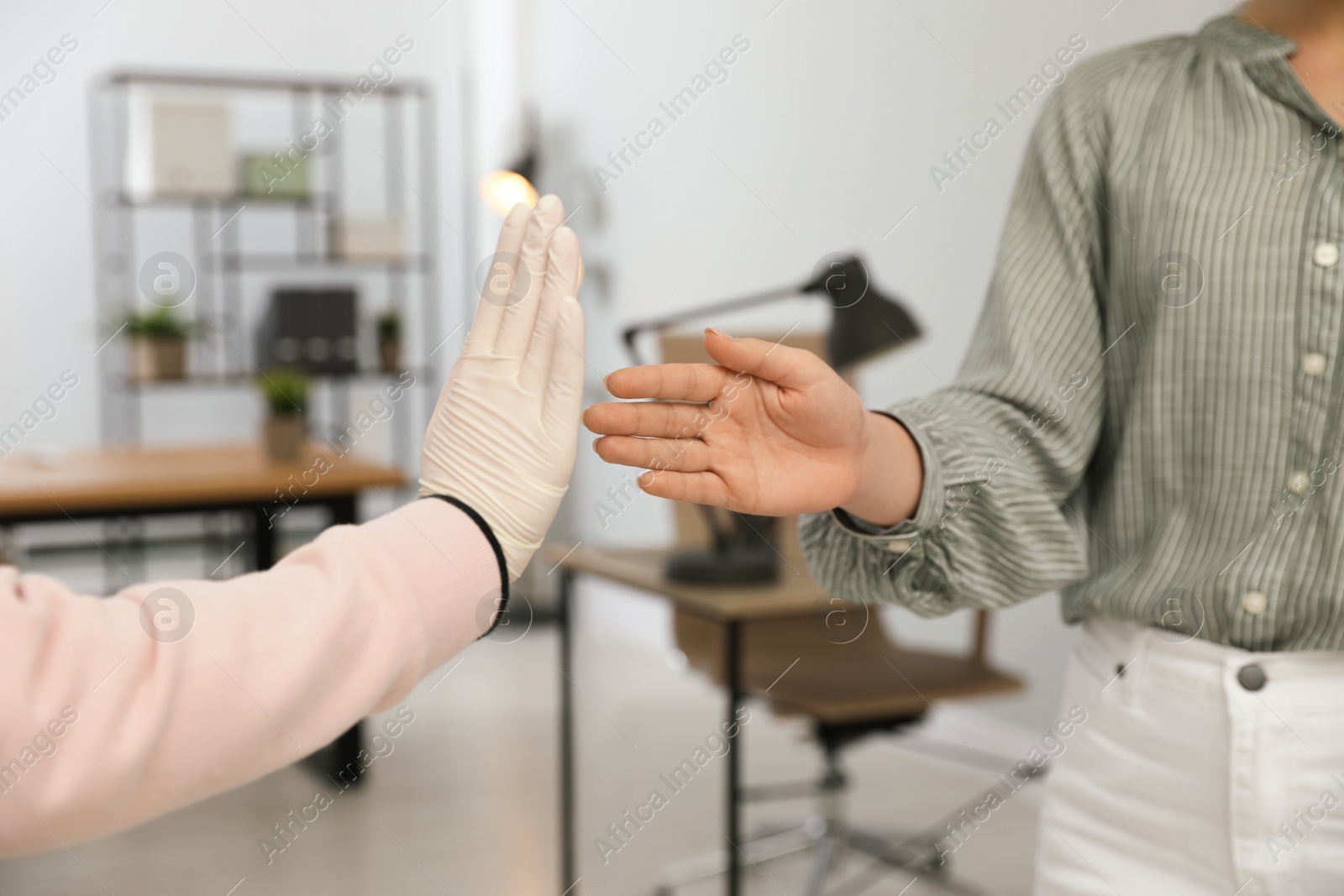 Woman refusing handshake from coworker in office, closeup Photo of Woman refusing handshake from coworker in office, closeup