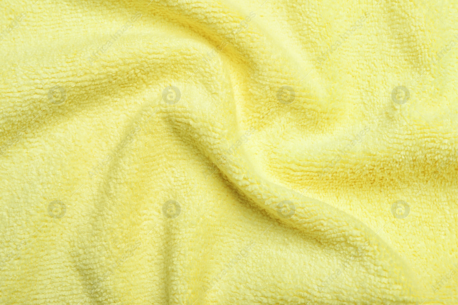 Crumpled pale yellow microfiber cloth as background, closeup Photo of Crumpled pale yellow microfiber cloth as background, closeup
