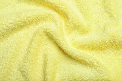 Crumpled pale yellow microfiber cloth as background, closeup Photo of Crumpled pale yellow microfiber cloth as background, closeup