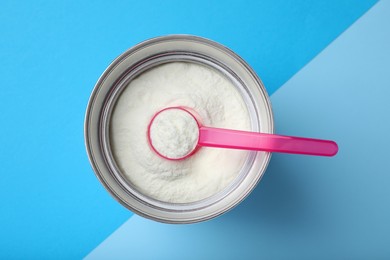Can of powdered infant formula with scoop on color background, top view. Baby milk Photo of Can of powdered infant formula with scoop on color background, top view. Baby milk