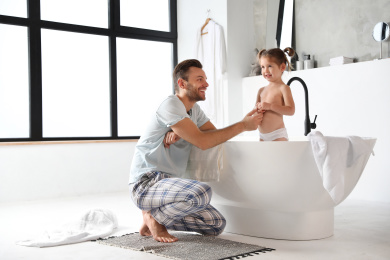 Father and his cute little daughter in bathroom Photo of Father and his cute little daughter in bathroom