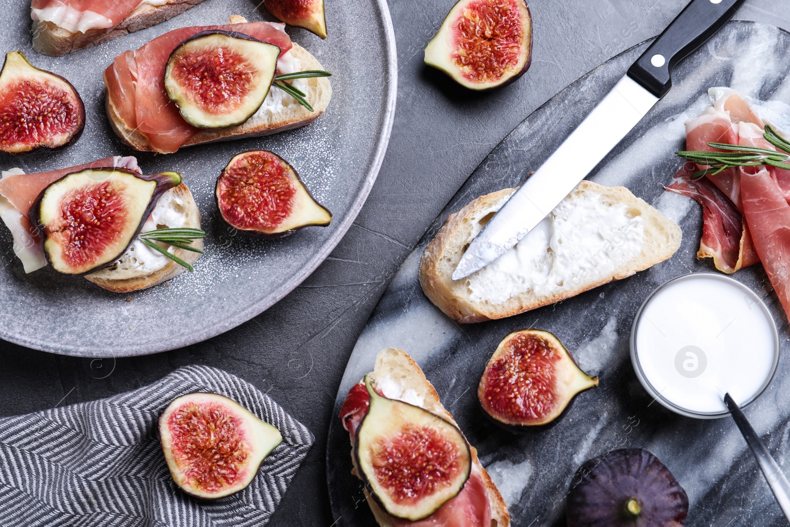Sandwiches with ripe figs, cream cheese and prosciutto served on black table, flat lay Photo of Sandwiches with ripe figs, cream cheese and prosciutto served on black table, flat lay