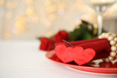 Elegant place setting on white table, closeup with space for text. Valentine's day romantic dinner Photo of Elegant place setting on white table, closeup with space for text. Valentine's day romantic dinner