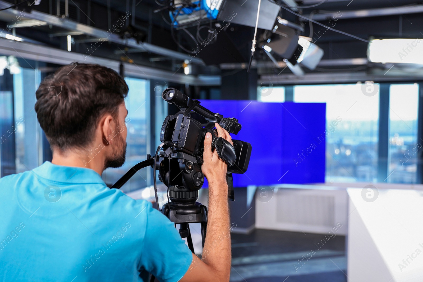 Photo of Professional video camera operator working in studio