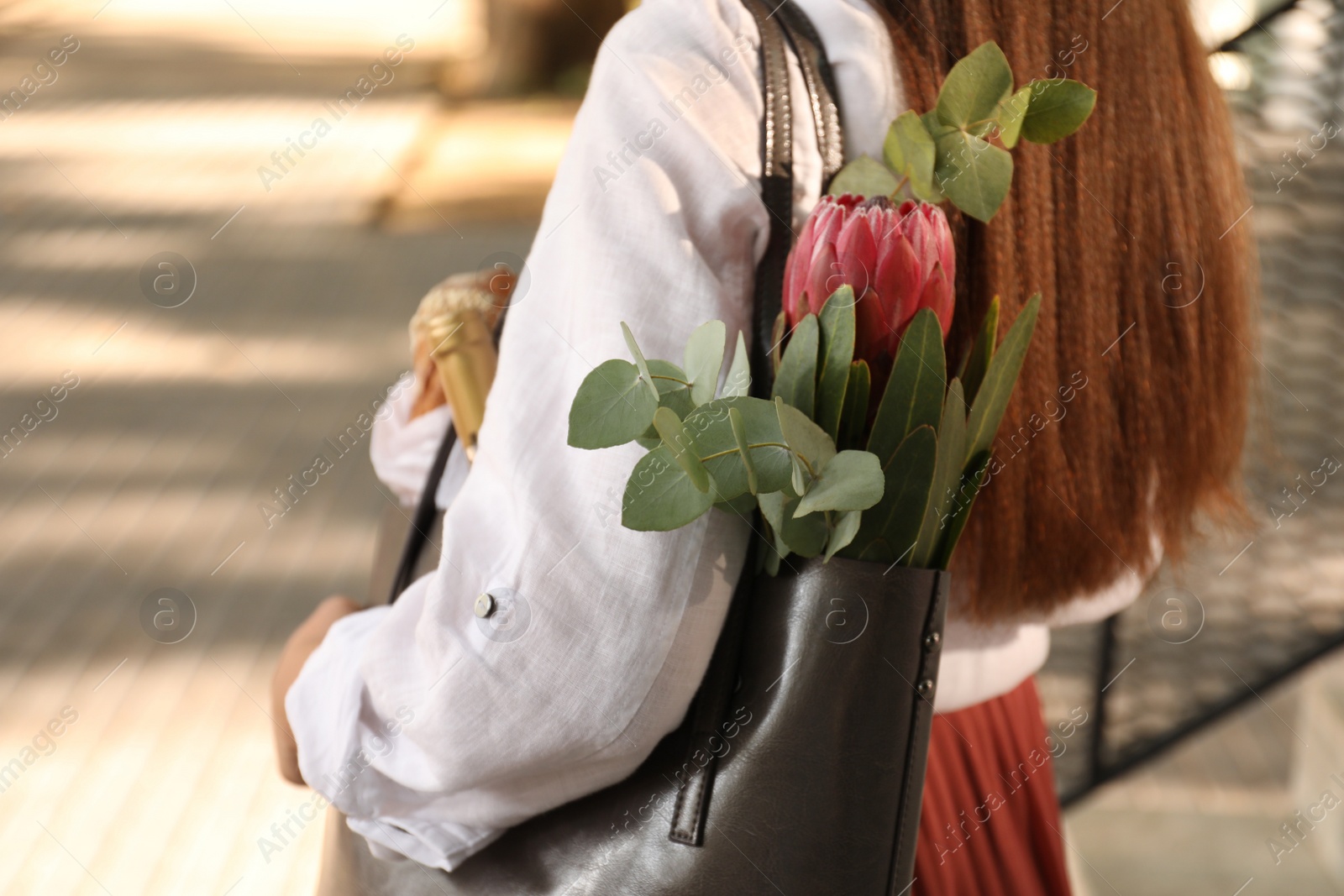 Woman with leather shopper bag outdoors, closeup Photo of Woman with leather shopper bag outdoors, closeup