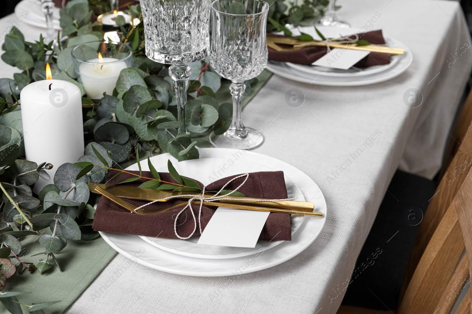 Luxury table setting with beautiful decor and blank cards. Festive dinner Photo of Luxury table setting with beautiful decor and blank cards. Festive dinner