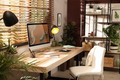 Light room interior with comfortable workplace near window Photo of Light room interior with comfortable workplace near window