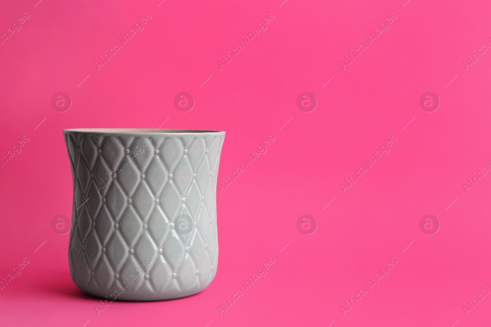 Stylish empty ceramic vase on pink background, space for text Photo of Stylish empty ceramic vase on pink background, space for text