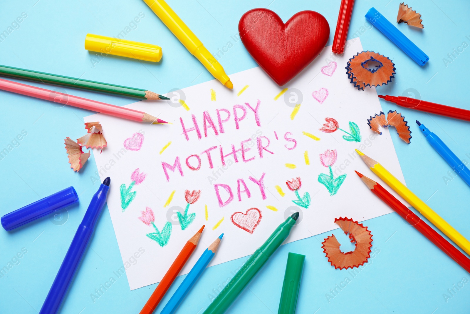 Photo of Flat lay composition with drawing for Mother's day on light blue background