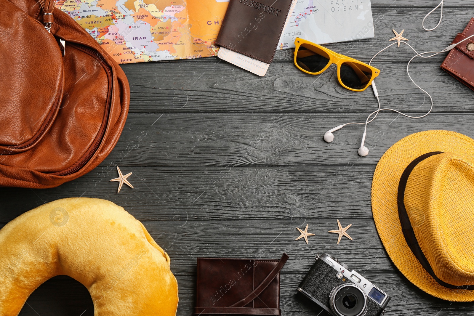 Flat lay composition with yellow travel pillow on wooden background, space for text Image of Flat lay composition with yellow travel pillow on wooden background, space for text