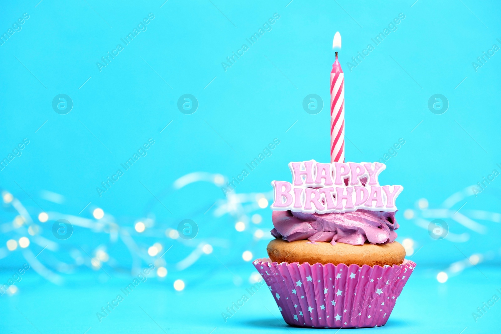Birthday cupcake with candle on color background Photo of Birthday cupcake with candle on color background