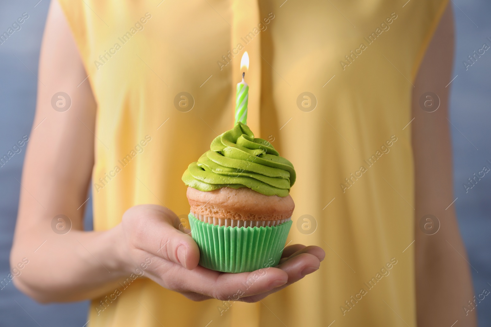 Woman holding birthday cupcake, closeup Photo of Woman holding birthday cupcake, closeup