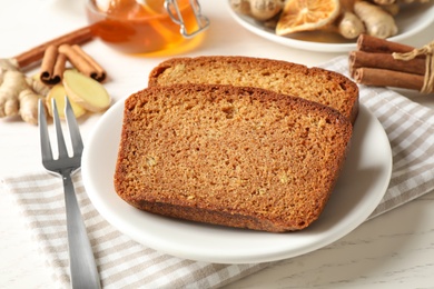 Fresh gingerbread cake slices served on white wooden table, closeup Photo of Fresh gingerbread cake slices served on white wooden table, closeup