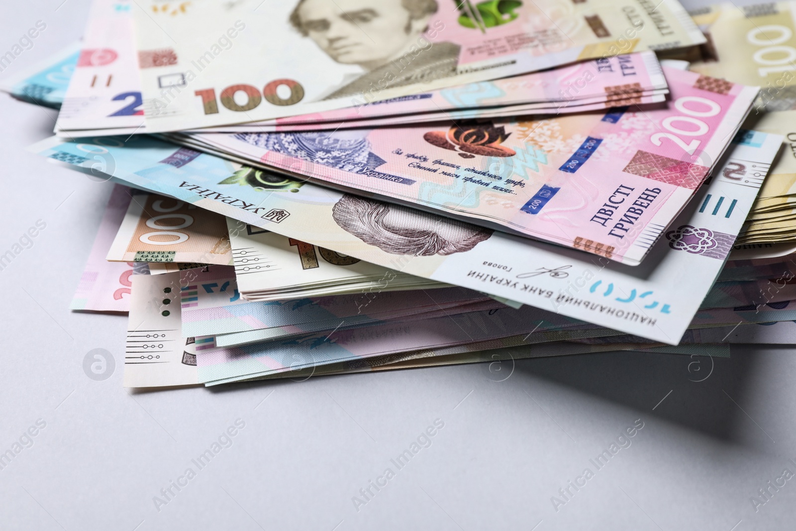 Ukrainian money on light grey background, closeup. National currency Photo of Ukrainian money on light grey background, closeup. National currency