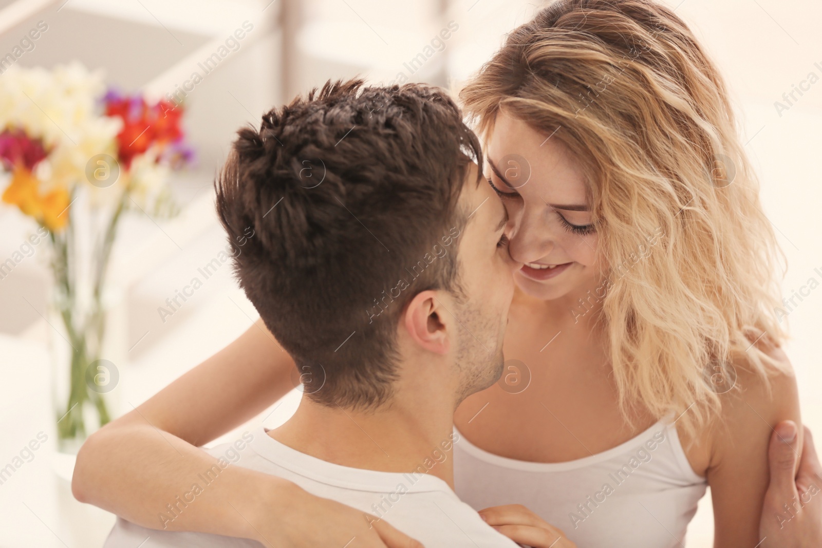 Happy young couple hugging at home Photo of Happy young couple hugging at home