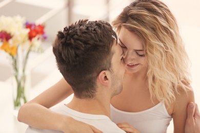 Happy young couple hugging at home Photo of Happy young couple hugging at home