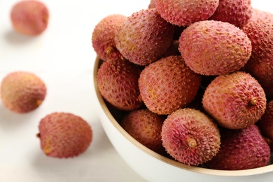 Fresh ripe lychees in bowl, closeup. Space for text Photo of Fresh ripe lychees in bowl, closeup. Space for text