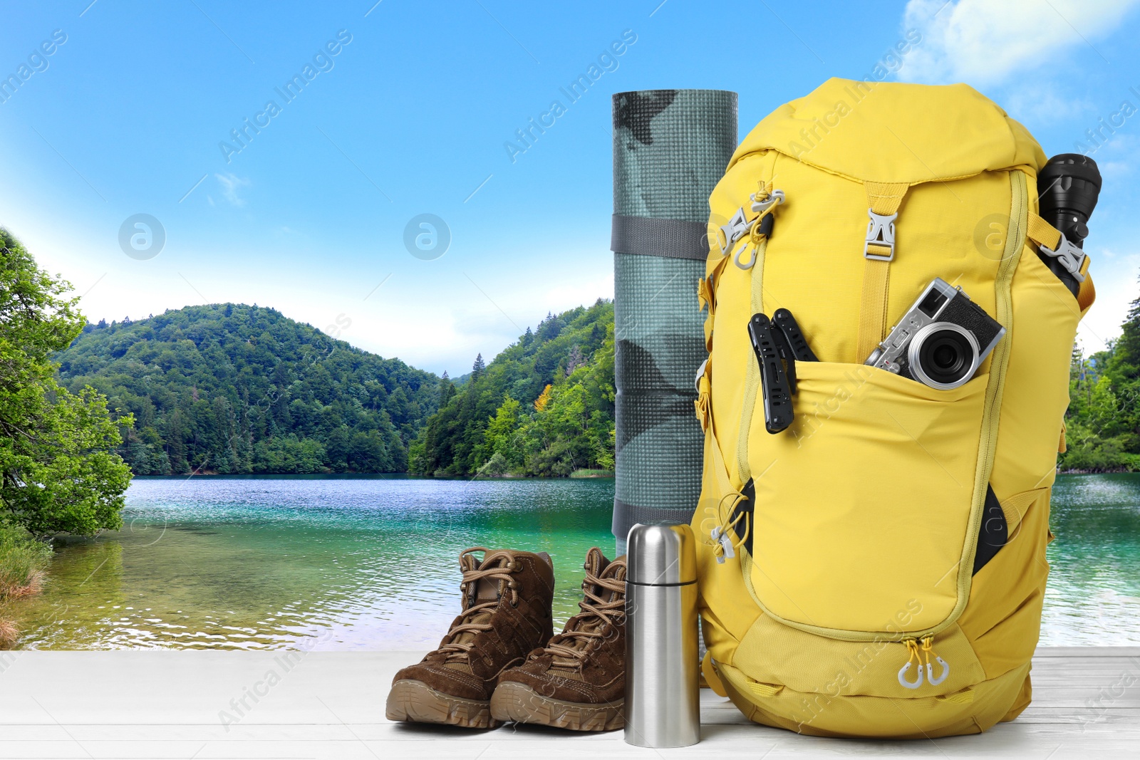 Camping equipment for tourist on wooden surface and beautiful view of mountain landscape Image of Camping equipment for tourist on wooden surface and beautiful view of mountain landscape