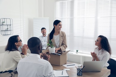 Group of coworkers welcoming new employee in team indoors Photo of Group of coworkers welcoming new employee in team indoors