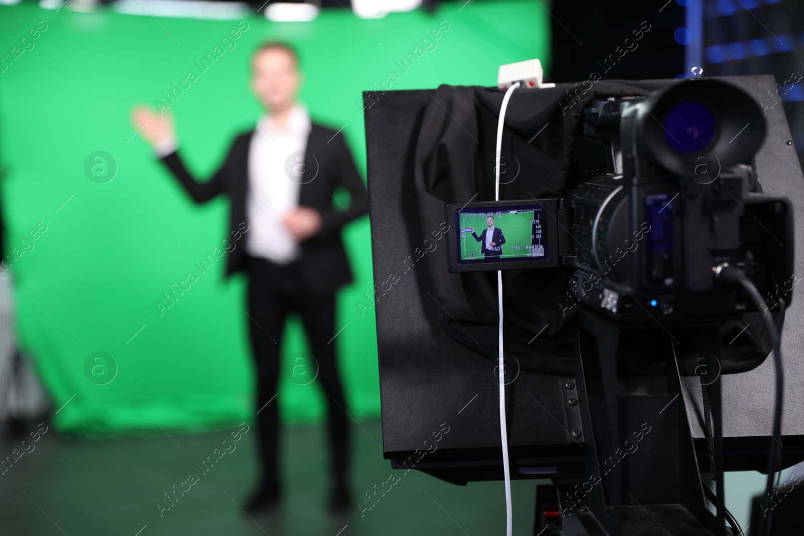 Presenter working in studio, focus on video camera screen Photo of Presenter working in studio, focus on video camera screen