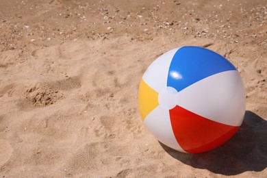 Colorful inflatable ball on sandy beach. Space for text Photo of Colorful inflatable ball on sandy beach. Space for text