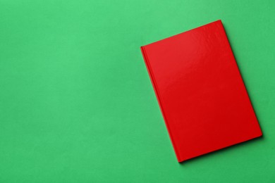 New stylish planner with hard cover on green background, top view. Space for text Photo of New stylish planner with hard cover on green background, top view. Space for text