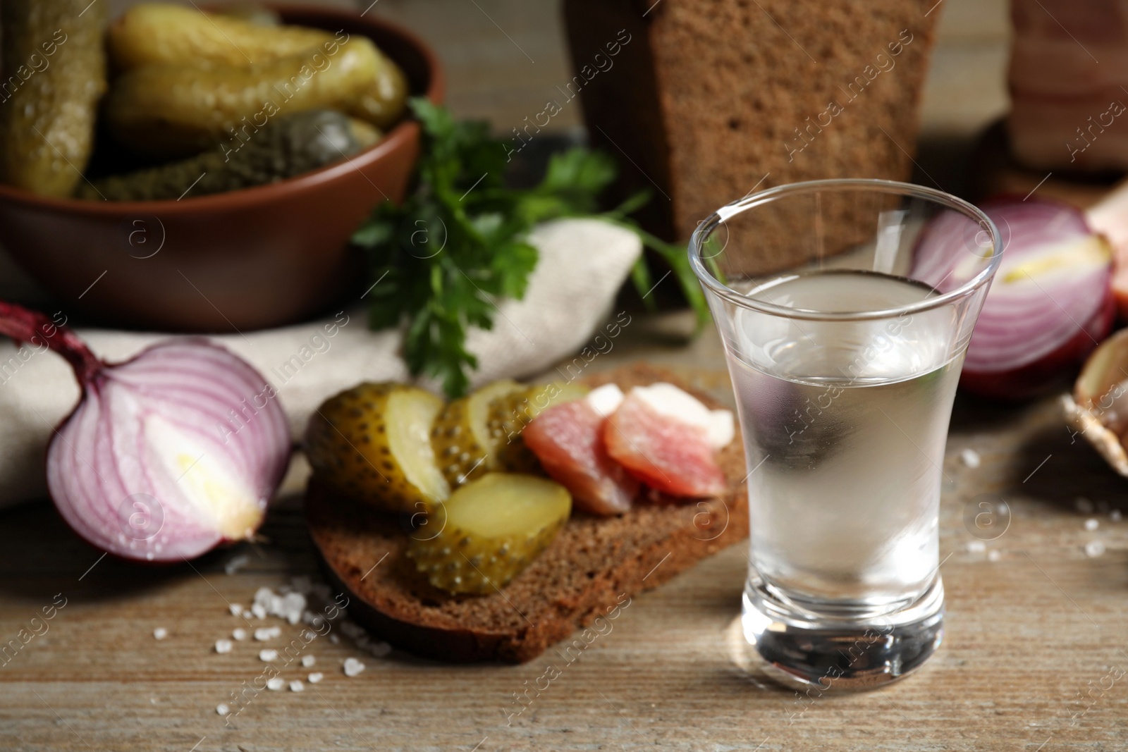 Cold Russian vodka with snacks on wooden table, closeup Photo of Cold Russian vodka with snacks on wooden table, closeup