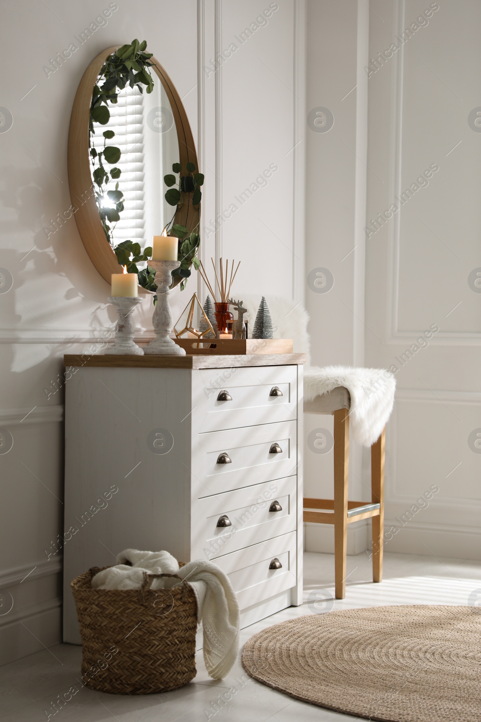Modern room interior with chest of drawers and mirror on white wall Photo of Modern room interior with chest of drawers and mirror on white wall