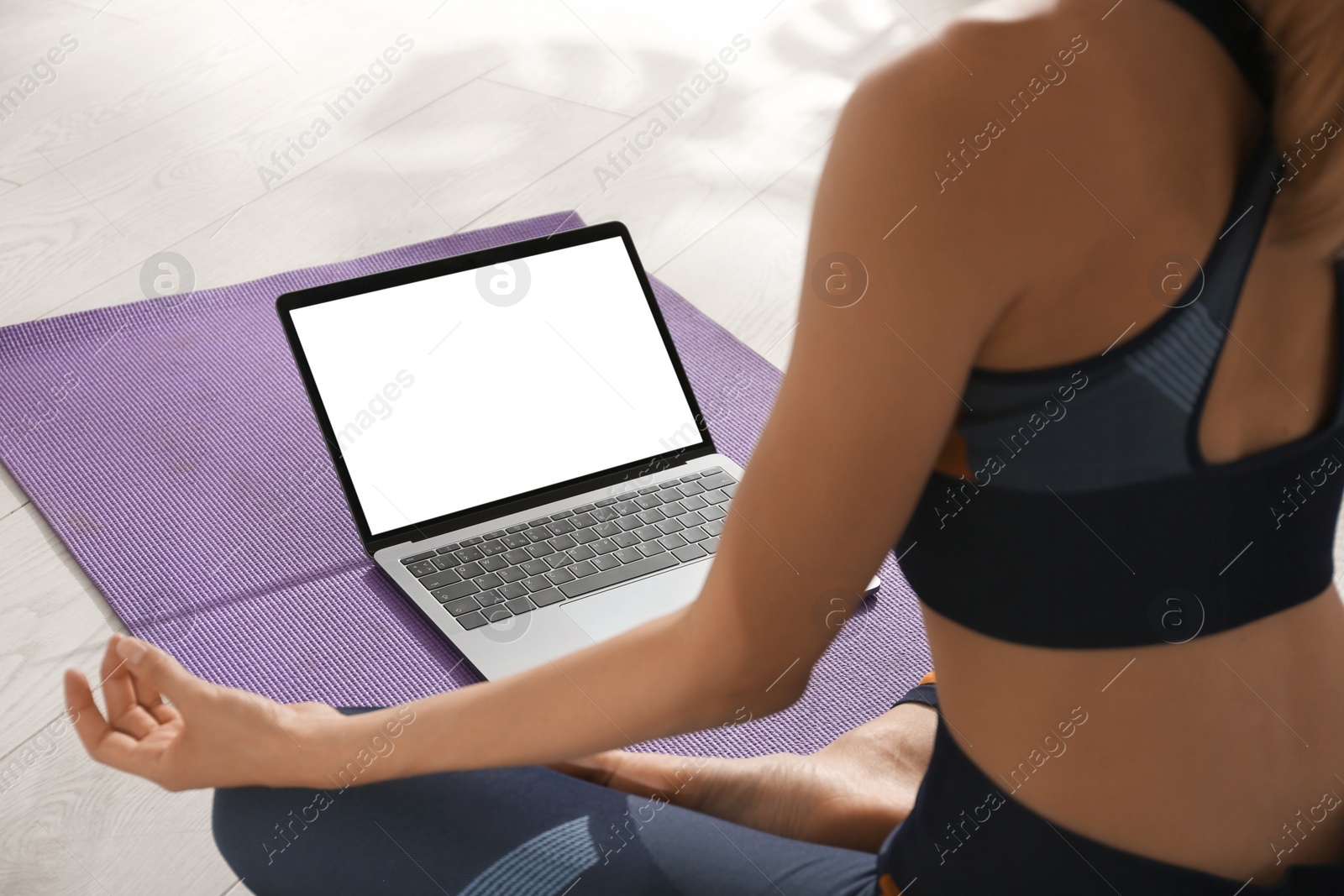 Woman having online video class via laptop at home, closeup. Distance yoga course during coronavirus pandemic Photo of Woman having online video class via laptop at home, closeup. Distance yoga course during coronavirus pandemic