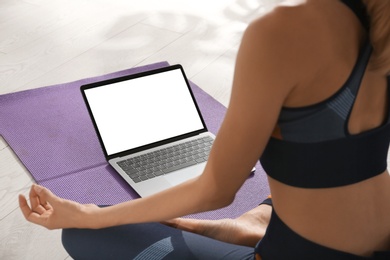 Woman having online video class via laptop at home, closeup. Distance yoga course during coronavirus pandemic Photo of Woman having online video class via laptop at home, closeup. Distance yoga course during coronavirus pandemic