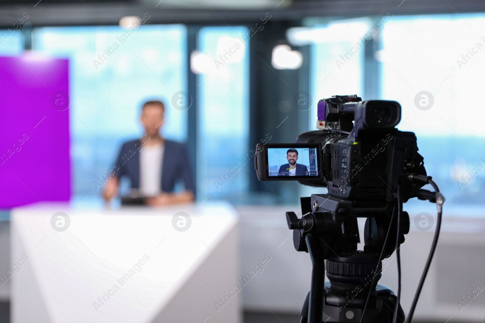 Presenter working in studio, focus on video camera Photo of Presenter working in studio, focus on video camera