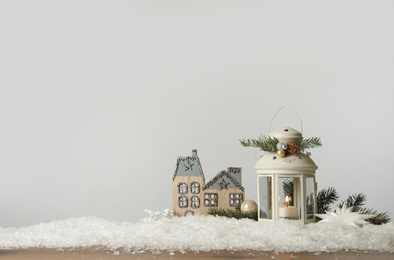 Beautiful composition with vintage Christmas lantern and festive decorations on snow against white background. Space for text Photo of Beautiful composition with vintage Christmas lantern and festive decorations on snow against white background. Space for text