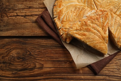 Traditional galette des Rois on wooden table, above view. Space for text Photo of Traditional galette des Rois on wooden table, above view. Space for text