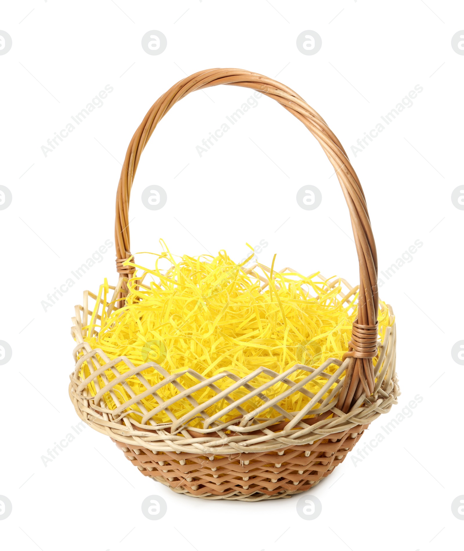 Wicker basket with yellow filler isolated on white. Easter item Photo of Wicker basket with yellow filler isolated on white. Easter item