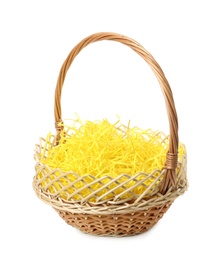 Wicker basket with yellow filler isolated on white. Easter item Photo of Wicker basket with yellow filler isolated on white. Easter item