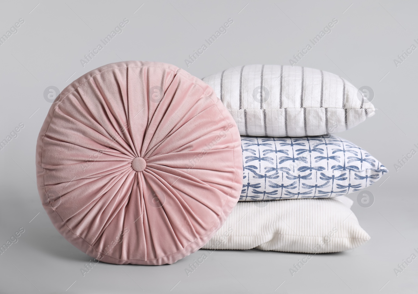 Photo of Different stylish soft pillows on grey background