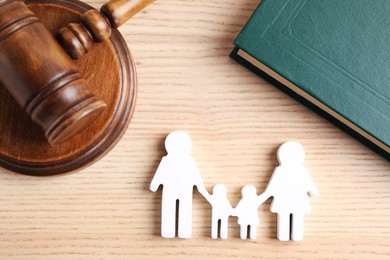 Family law concept. Judge gavel, family figure and book on wooden background, flat lay Image of Family law concept. Judge gavel, family figure and book on wooden background, flat lay