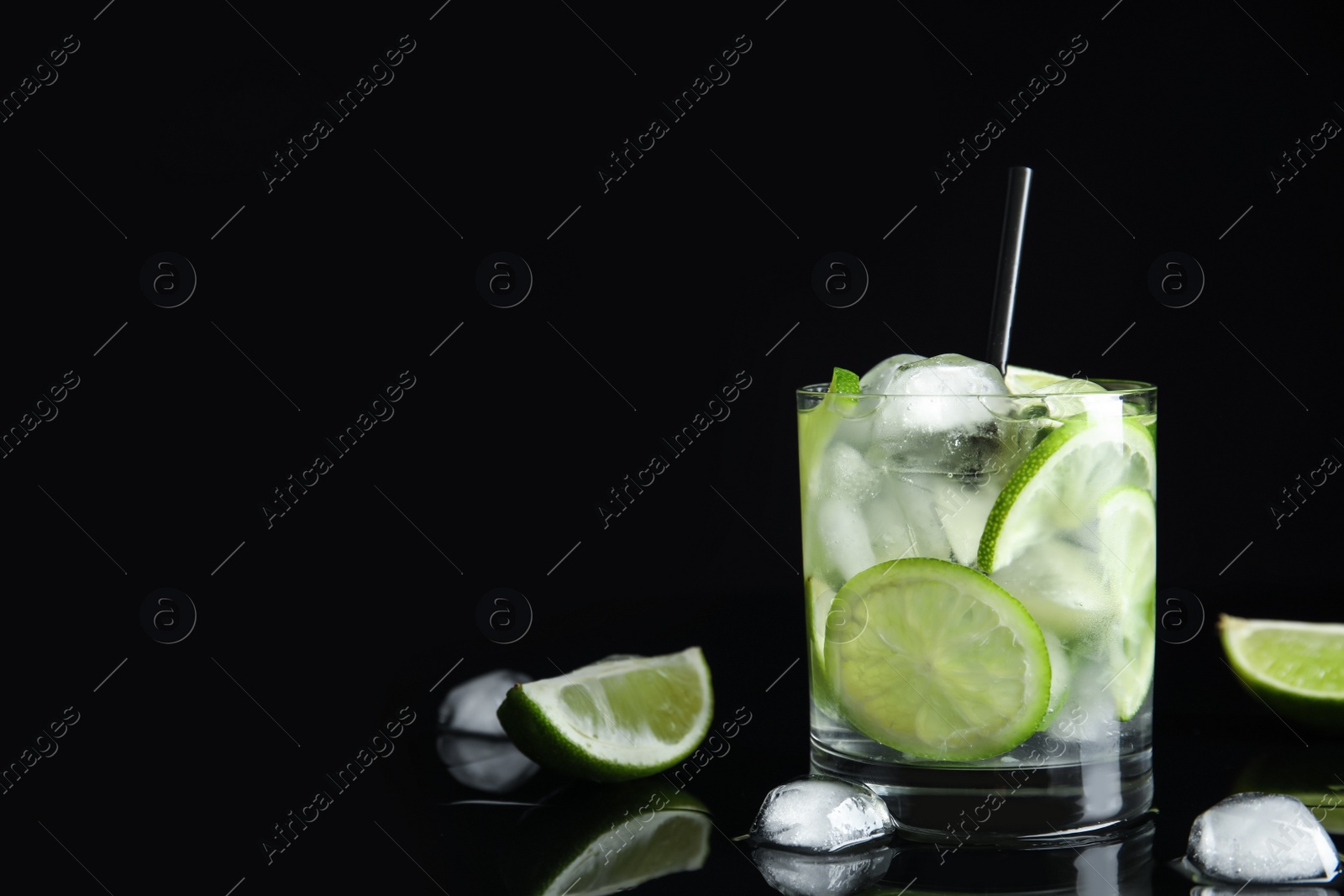Delicious mojito and ingredients on black background. Space for text Photo of Delicious mojito and ingredients on black background. Space for text