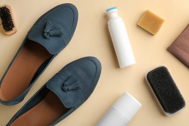 Stylish footwear with shoe care accessories on beige background, flat lay Photo of Stylish footwear with shoe care accessories on beige background, flat lay