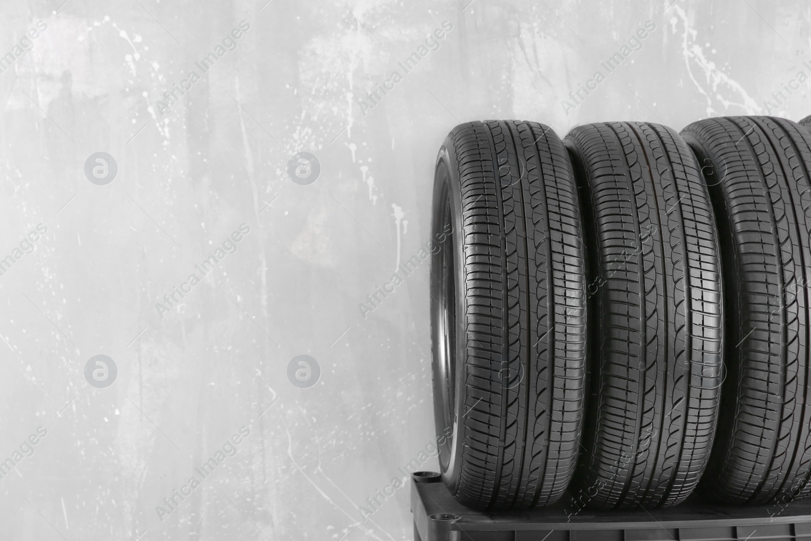 Car tires on grey background Photo of Car tires on grey background