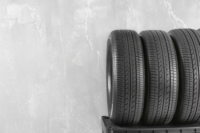 Car tires on grey background Photo of Car tires on grey background