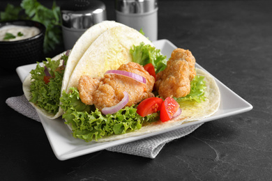 Delicious fish tacos served on dark table Photo of Delicious fish tacos served on dark table