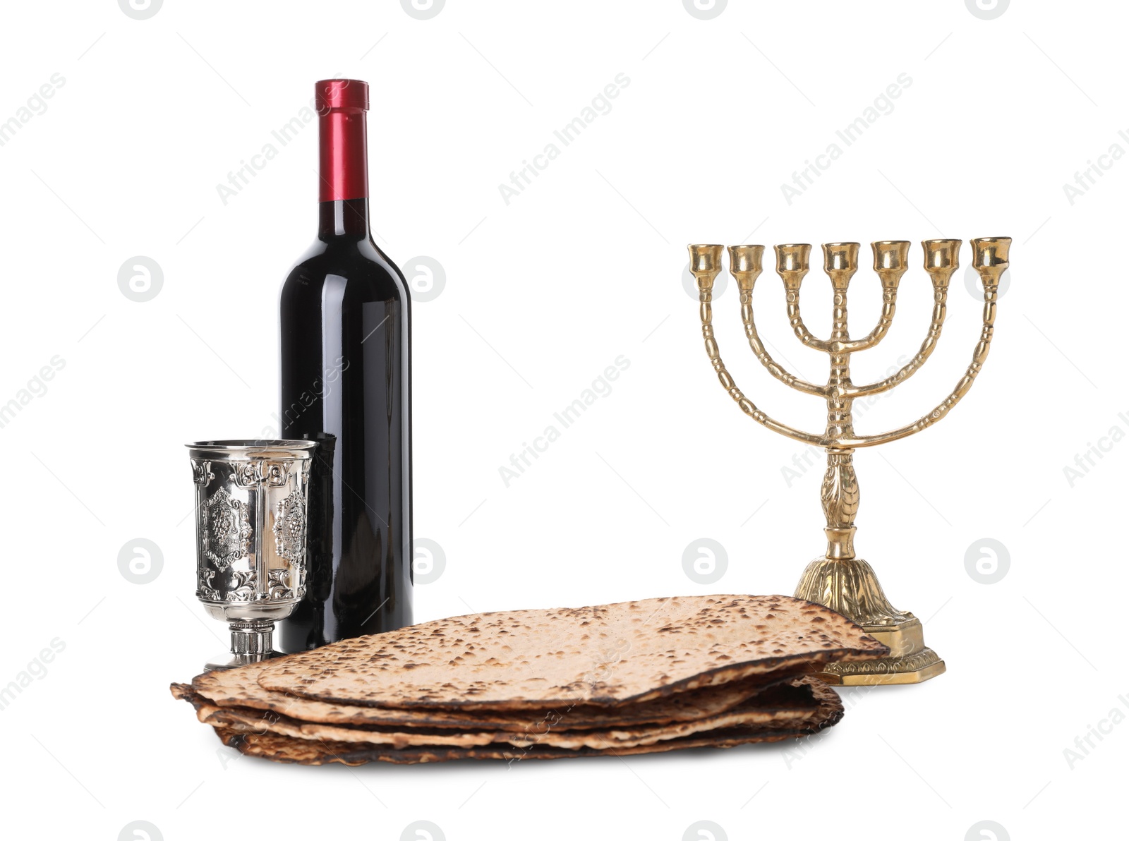 Tasty matzos, wine and menorah on white background. Passover (Pesach) celebration Photo of Tasty matzos, wine and menorah on white background. Passover (Pesach) celebration