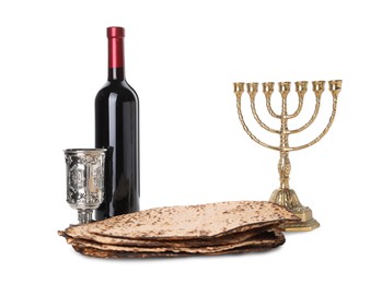 Photo of Tasty matzos, wine and menorah on white background. Passover (Pesach) celebration