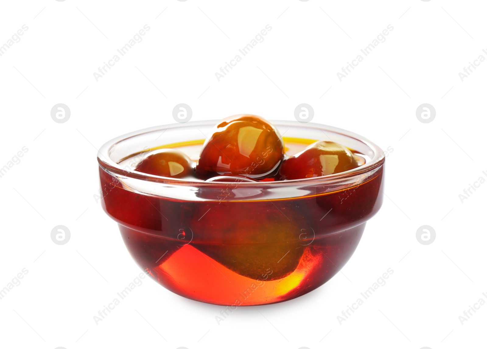 Palm oil and fruits in glass bowl isolated on white Photo of Palm oil and fruits in glass bowl isolated on white