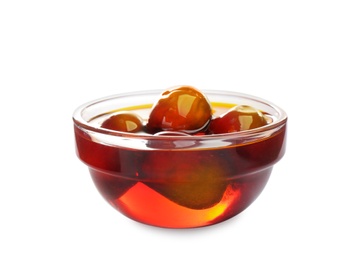 Palm oil and fruits in glass bowl isolated on white Photo of Palm oil and fruits in glass bowl isolated on white