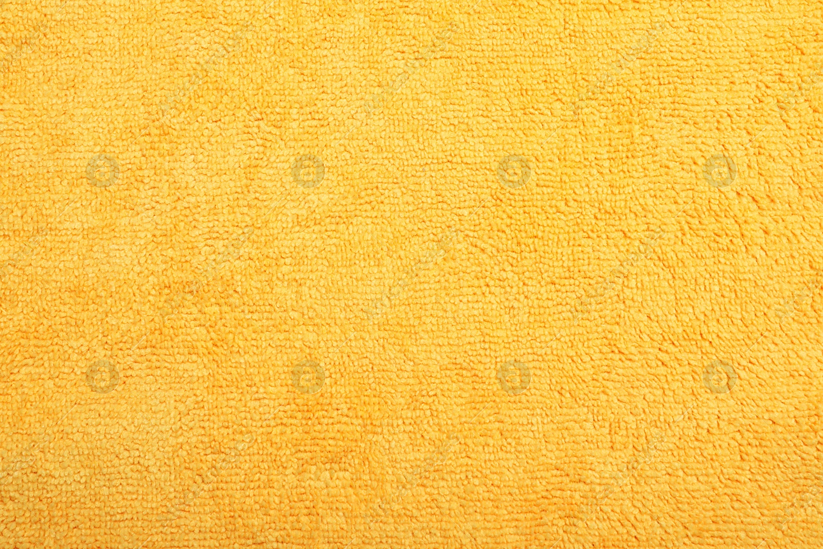Orange microfiber cloth as background, top view Photo of Orange microfiber cloth as background, top view
