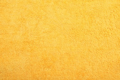 Orange microfiber cloth as background, top view Photo of Orange microfiber cloth as background, top view