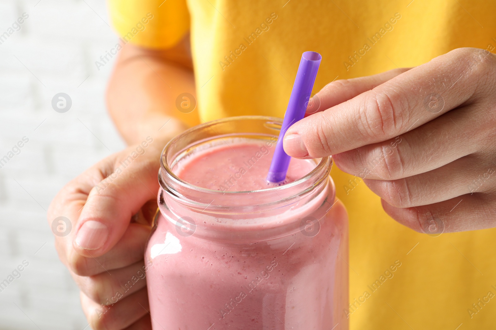 Woman with mason jar of tasty smoothie, closeup Image of Woman with mason jar of tasty smoothie, closeup