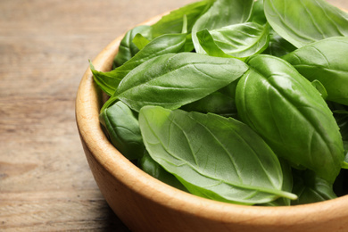 Fresh basil leaves on wooden table, closeup Photo of Fresh basil leaves on wooden table, closeup